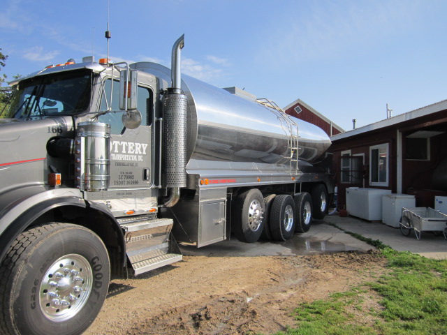 The milk truck pulls up to the milk cooling tank outside the milking parlor.
