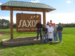 Family standing by our creamery sign